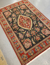 Load image into Gallery viewer, Area Rug from Iran with a Black field and Red border and floral and birds Geometric pattern